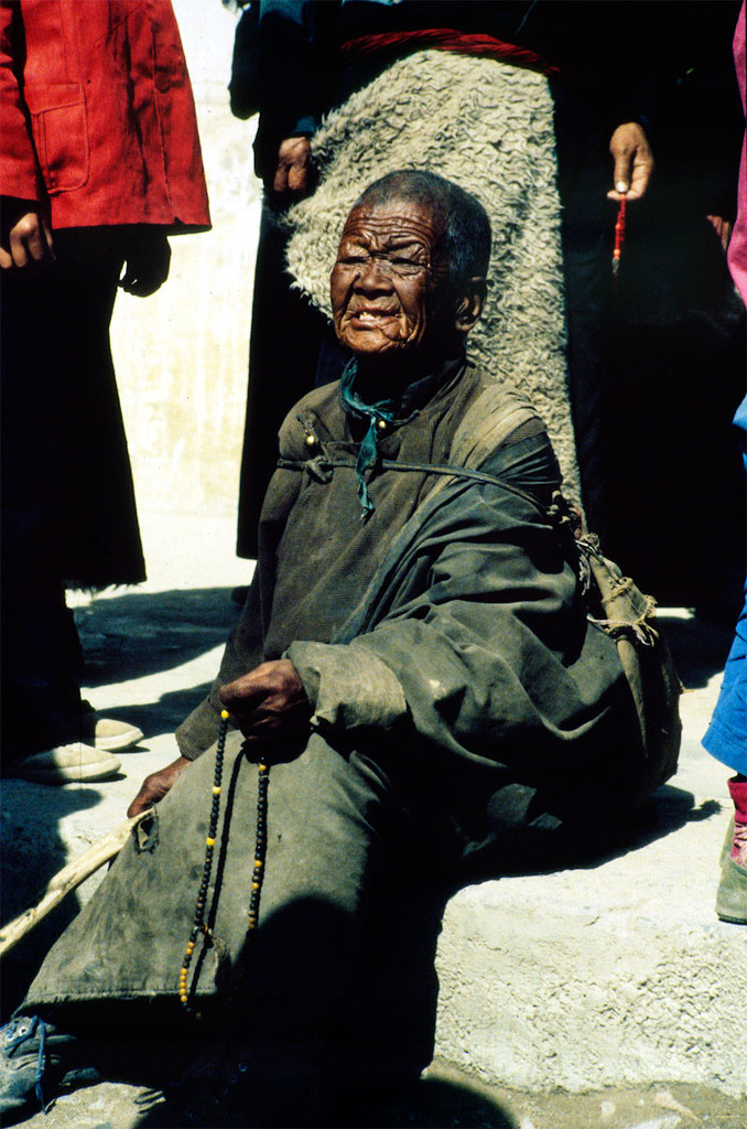 Vejrbidt ældre tibetansk kvinde i Xiahe i Gansu provinsen