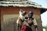 A woman proudly show her kid in a village near Masvingo